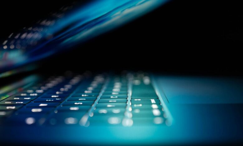 closeup photo of turned-on blue and white laptop computer