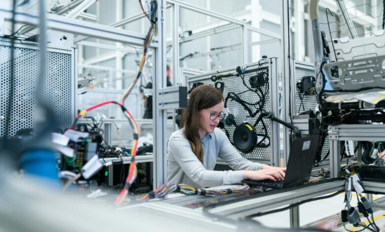 woman in white long sleeve shirt using black laptop computer